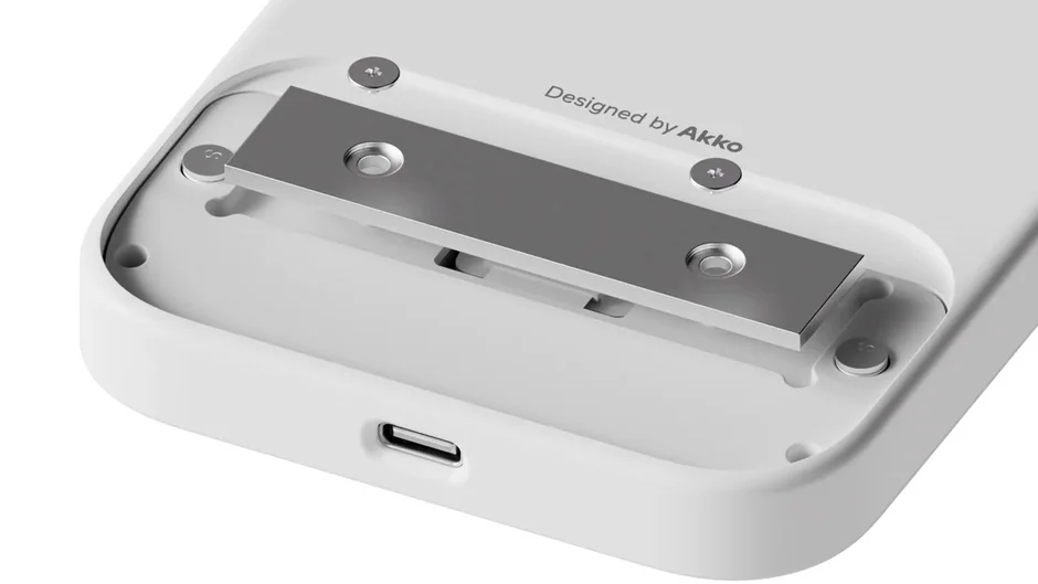 白い電子機器の底面部分をクローズアップした画像で、USB-Cポート、金属製のプレートとネジが見えます。「Designed by Akko」の文字が読み取れます。