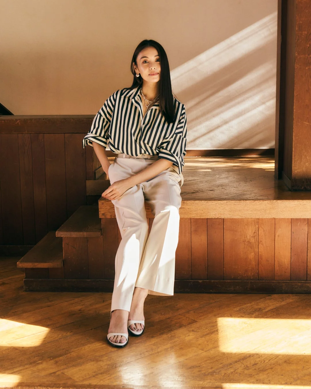 ストライプシャツとパンツを着用した女性