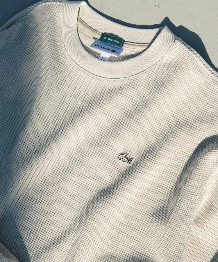 ラコステのオフホワイトのワッフルニットスウェットシャツ