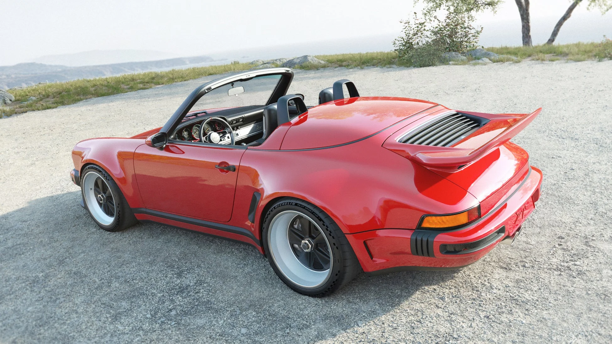 山道に駐車された鮮やかな赤いオープンカーのスポーツカー